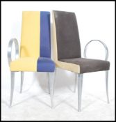 A  pair of contemporary Art Deco modernist dining chairs constructed of polished steel frames with