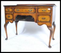A Queen Anne style walnut lowboy desk. Raised on cabriole legs with pad feet having a series of