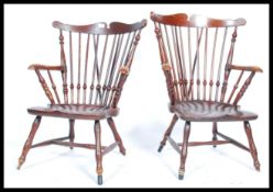 A pair of 19th century elm hoop spindle back nursing / fireside Windsor armchairs having saddle