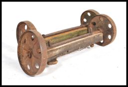 A pair of 19th century Industrial Victorian Cast Iron dram wheels. Each with wooden axles, the