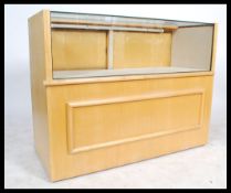A 20th century contemporary beech wood effect glazed shop counter, with fitted glazed viewing area