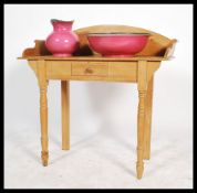 A late 19th / early 20th century stripped pine wash stand with single frieze drawer raised on turned