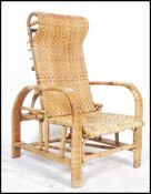 A vintage 20th century cane and whicker garden / plantation chair having an open bamboo frame with