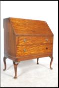 An Edwardian mahogany ladies writing bureau desk - bonheur de jour being raised on cabriole legs