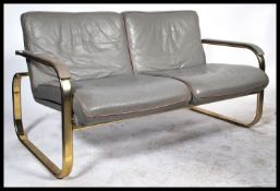 A 1970's vintage industrial grey leather two seater sofa / settee in the manner of pieff made from a