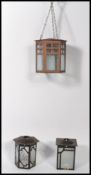 A collection of three early 20th century Art Deco hanging porch lanterns, each fitted with glass