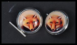 A pair of sterling silver and enamel cuff-links having pictorial images of foxes , hunting interest.