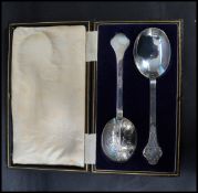 A cased set of early 20th century silver hallmarked large serving spoons bearing hallmarked for