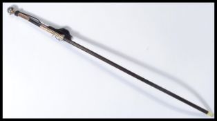 A vintage 20th century ladies walking stick cane having a tapering ebonised shaft with embossed
