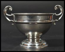 An early 20th century silver hallmarked Edwardian sugar bowl with Georgian style scrolled handles