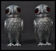 A pair of antique style owl condiments with inset red glass eyes - each stamped 800 (indicating
