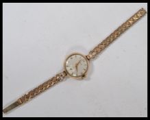 A ladies 9ct hallmarked gold Certina cocktail watch, silvered dial with gold batons, subsidiary