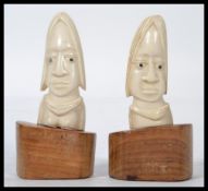 A pair of 19th century West African ivory fertility figures raised on carved plinth bases. Highest