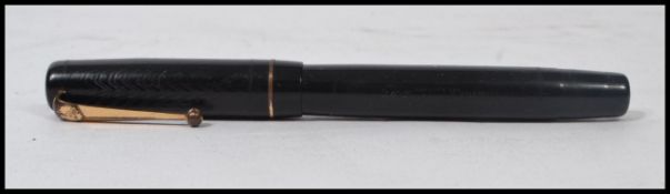 A Swan self filler Mabie Todd & Co, Ltd., fountain pen, fitted with a 14ct gold nib. Measures 12.5