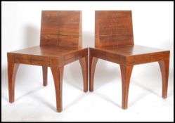 A pair of contemporary walnut Japanese low zen type easy lounge chairs having geometric Rennie