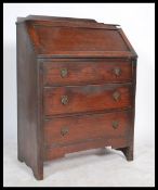A 20th century oak fall front bureau / desk with fully appointed interior over three graduating