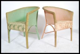 A pair of mid century Lloyd Loom style conservatory / bedroom armchairs. One in green, one pink,