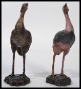 A pair of 20th century bronze cast figurines - sculptures of Ostrich to include a male and a