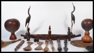 A collection of vintage 20th century African tribal items to include gourd water carriers, carved