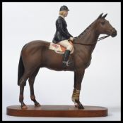 A Beswick Connoisseur model of Ann Moore on Psalm, raised to a wooden plinth. Condition in good