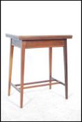 An Edwardian mahogany inlaid games / card table being raised on tapering angular legs with fitted