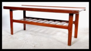 A 1970's retro 20th century teak wood coffee table of rectangular form having a slatted magazine