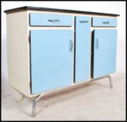 A stunning vintage mid 20th century free standing two tone kitchen unit having an arrangement of