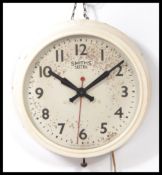 A vintage 1950's mid century industrial factory clock having notation to centre for Smiths