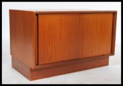 A retro 20th century G Plan teak wood low boy entertainment unit, two doors opening to reveal