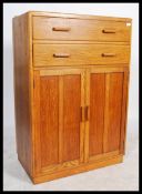 A vintage 20th century golden oak tall boy having an arrangement of two drawers over two full