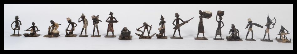 A good collection of Ashanti bronze figurines / gold weights to include hunter with bow , pot