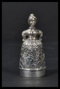 A sterling silver pin cushion and thimble in the form of a lady in dress. Weighs 23 grams.