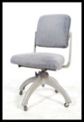 A retro mid 20th century industrial machinist chair adjustable seat pad and backrest raised on