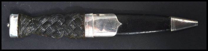 A Scottish dress dagger and sheaf dating from the 1960's, the handle carved from horn with