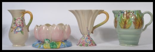 Clarice Cliff A group of four Art Deco pieces of Clarice Cliff ceramics to include three water