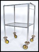 An original mid century Industrial surgeons theatre trolley of tubular metal and stainless steel