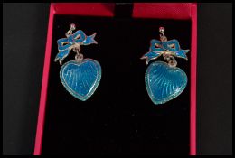 A pair of sterling silver and blue enamel drop earrings in the form of hearts and bows. Complete