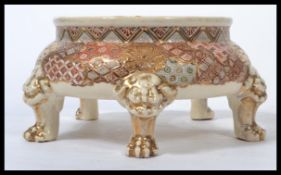 A late 19th century Oriental Japanese Satsuma vase stand raised on lion mask feet with hand