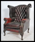 A 20th century Antique style oxblood leather chesterfield armchair being raised on cabriole legs