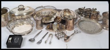 A large collection of silver plated wares to include , trays , toast rack , sugar tongs , wine