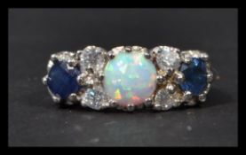 A sterling silver cz sapphire and opal dress ring. Weighs 5 grams.