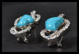 A pair of silver CZ and turquoise set earrings complete in presentation box.
