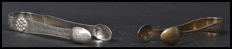 A pair of Georgian sugar nips with chase decoration together with another smaller pair. Total weight