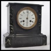 A 19th century Victorian marble slate mantel clock having a white enamel face with Roman numeral