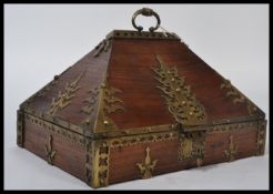 A stunning Chinese 20th century Sarcophagus shaped elm and brass chest, Brass carry handle atop to