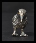 A sterling silver figurine of a water bird with stone eyes. Weighs 10.5 grams.