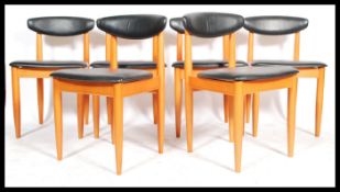 A set of 6 retro 20th century Danish influenced teak wood dining chairs, Raised on squared legs with