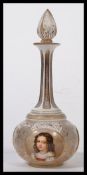 A 19th century Bohemian faceted cut glass gilt and enamelled decanter decorated with three hand
