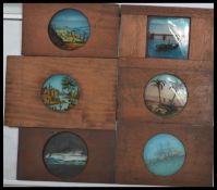 A collection of 19th century Victorian hand coloured glass plat magic lantern slides in wooden