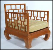 A 20th century Chinese hardwood armchair being rai